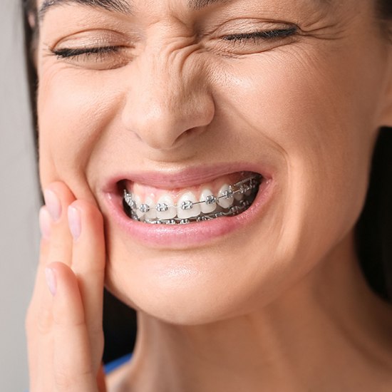 a patient with braces suffering from a toothache