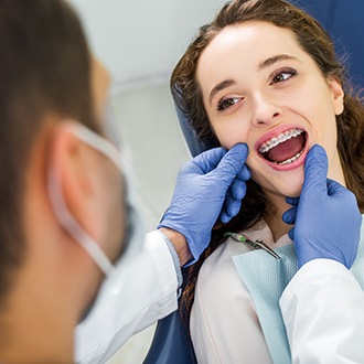 a patient with braces visiting her dentist