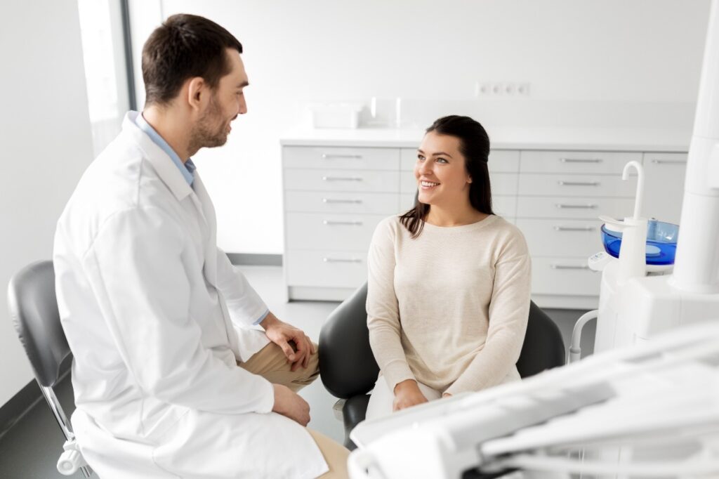 Dentist smiling at patient during consultation